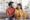 happy indian couple holding positive pregnancy test embracing home